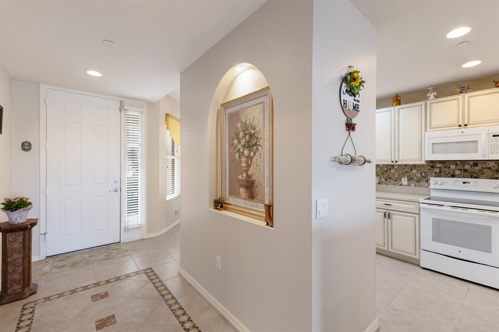 8414 Wethersfield Run, Unit 102 Lakewood Ranch, FL 34202 - Photo 5 of 48 a kitchen with stainless steel appliances granite countertop a refrigerator and a stove top oven