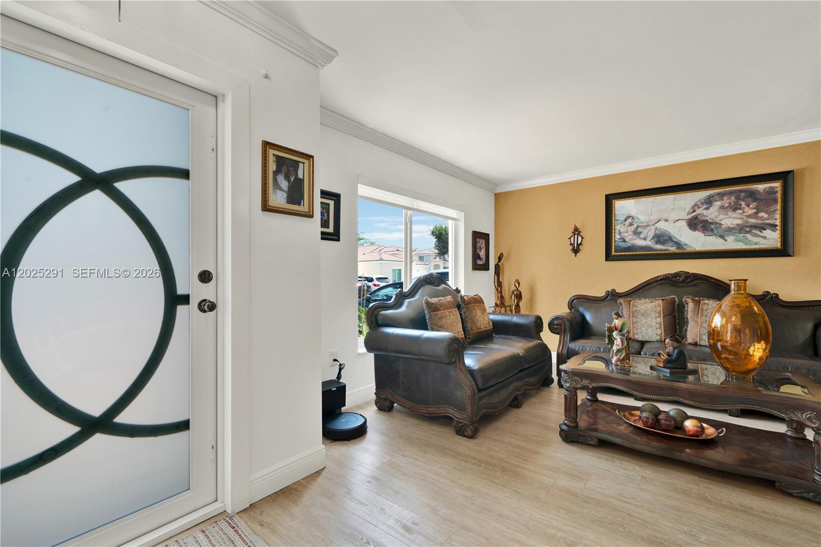 10006 Southwest 162nd Path Miami, FL 33196 - Photo 6 of 40 a living room with furniture a window and a flat screen tv