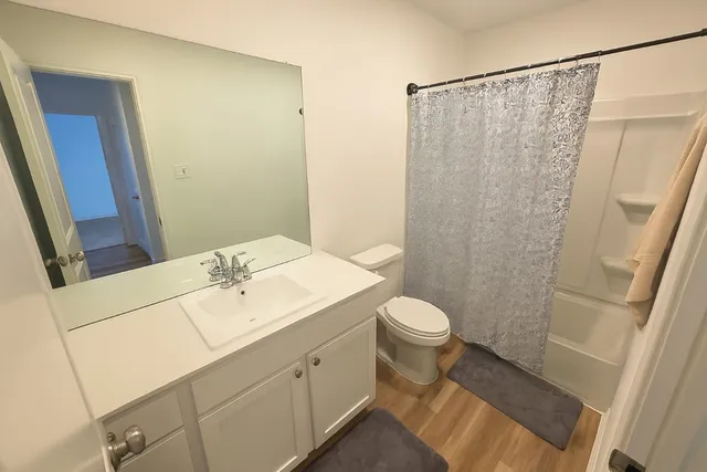 a bedroom with a bed and a painting on the wall