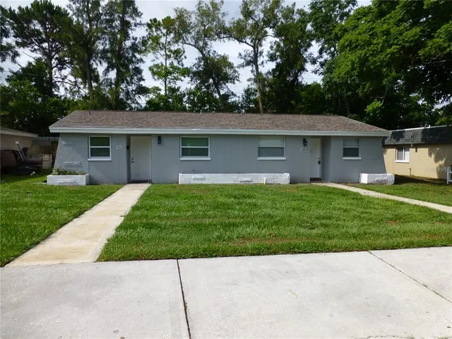 a front view of house with yard and green space