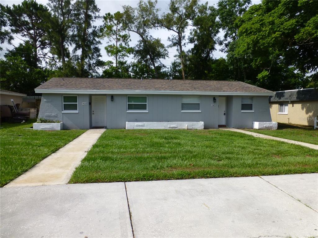 a front view of house with yard and green space