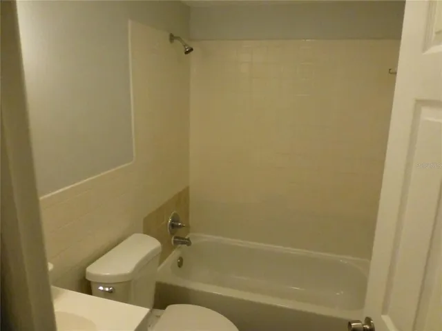 a bathroom with a toilet and bathtub