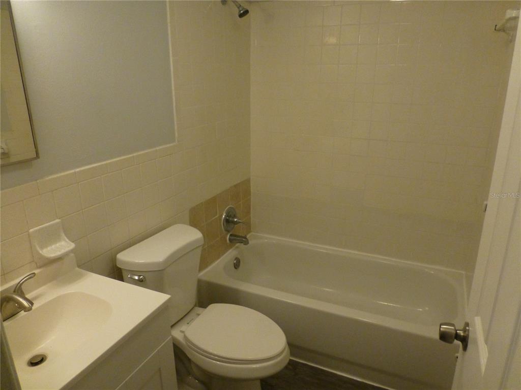 5420 Reef Drive New Port Richey, FL 34652 - Photo 13 of 14 a white toilet sitting next to a bath tub