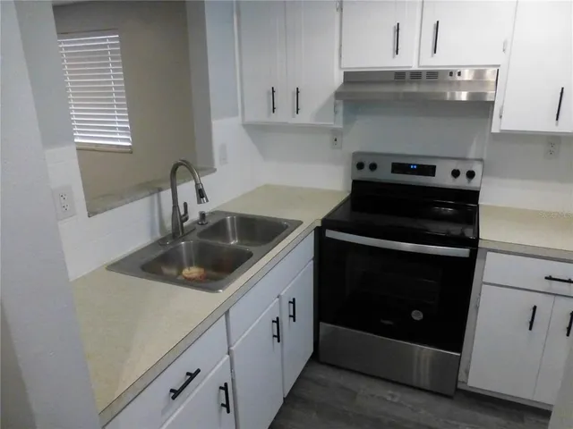 a kitchen with a sink and cabinets