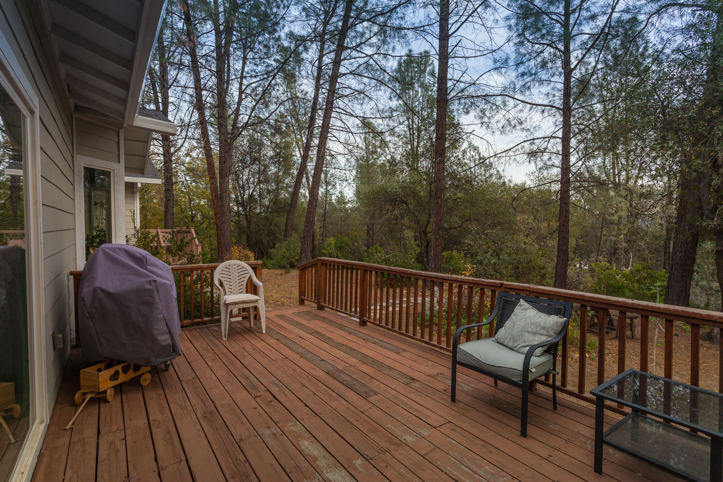 12199 Macs Road Redding, CA 96003 - Photo 19 of 36 a view of balcony with wooden floor and outdoor seating