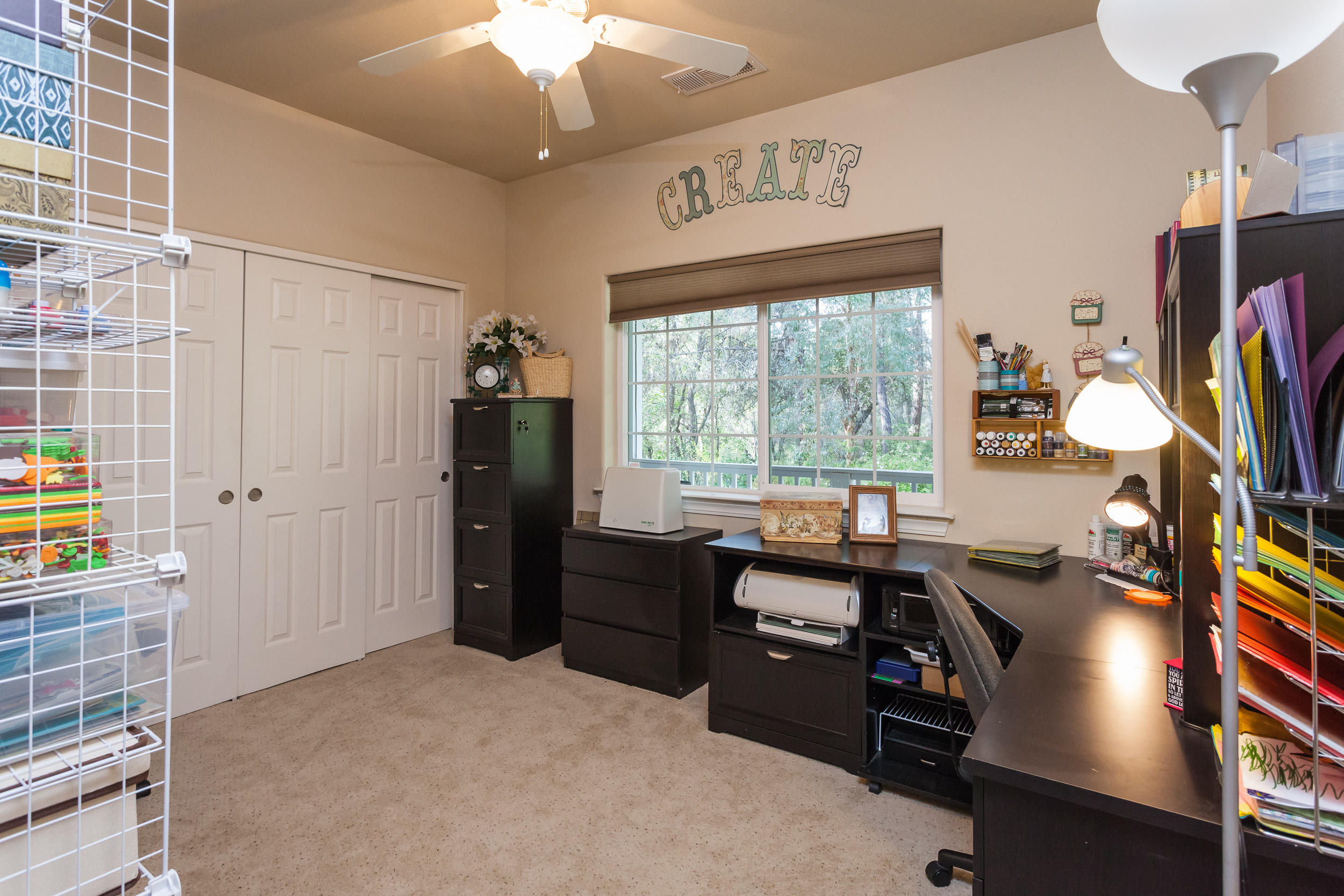 12199 Macs Road Redding, CA 96003 - Photo 20 of 36 a room with furniture a flat screen tv and a window