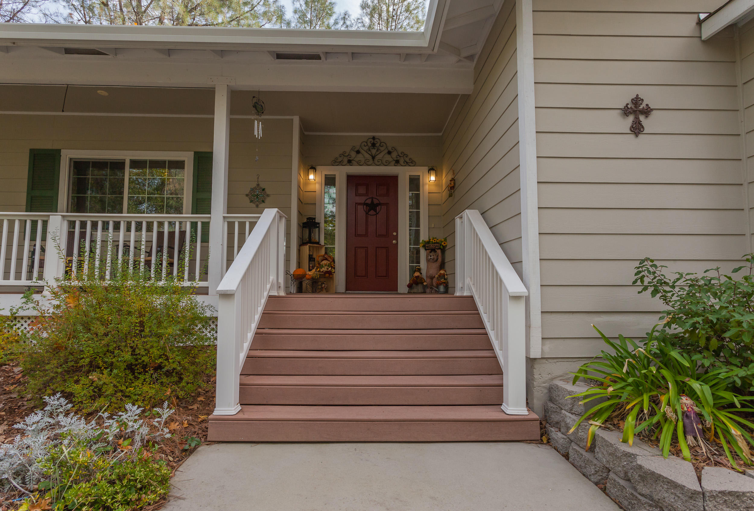 12199 Macs Road Redding, CA 96003 - Photo 2 of 36 a view of a pathway of a house with plants and wooden fence