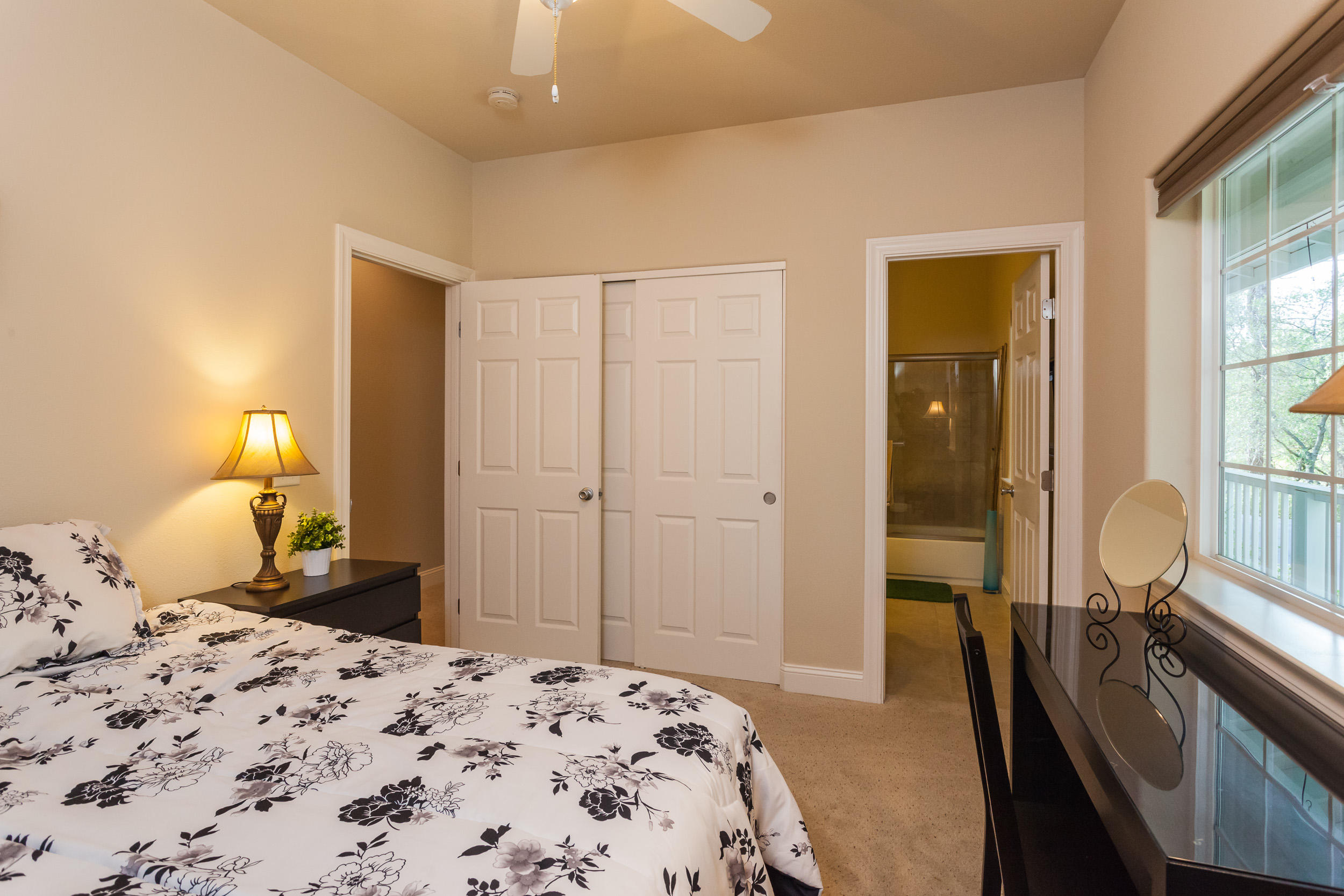 12199 Macs Road Redding, CA 96003 - Photo 23 of 36 a bedroom with a bed and wooden floor