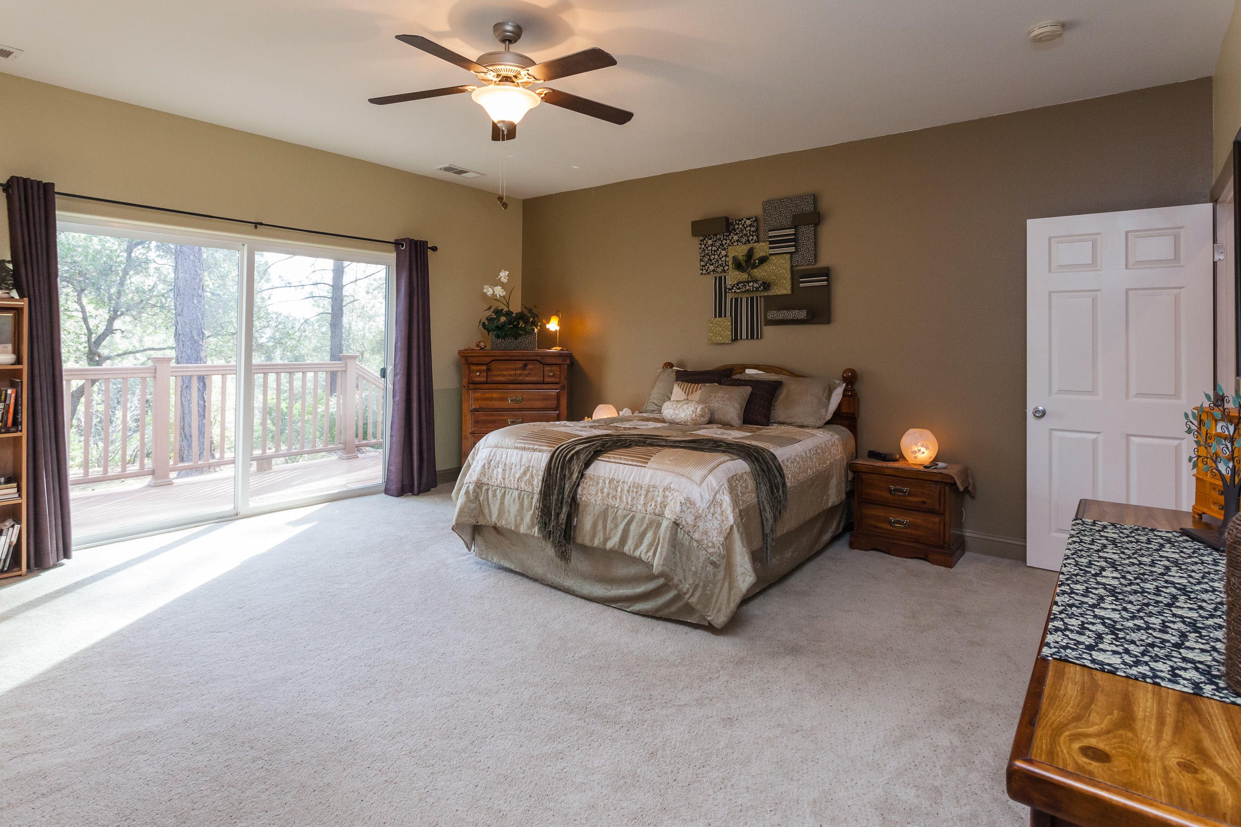 12199 Macs Road Redding, CA 96003 - Photo 26 of 36 a spacious bedroom with a bed and a couch