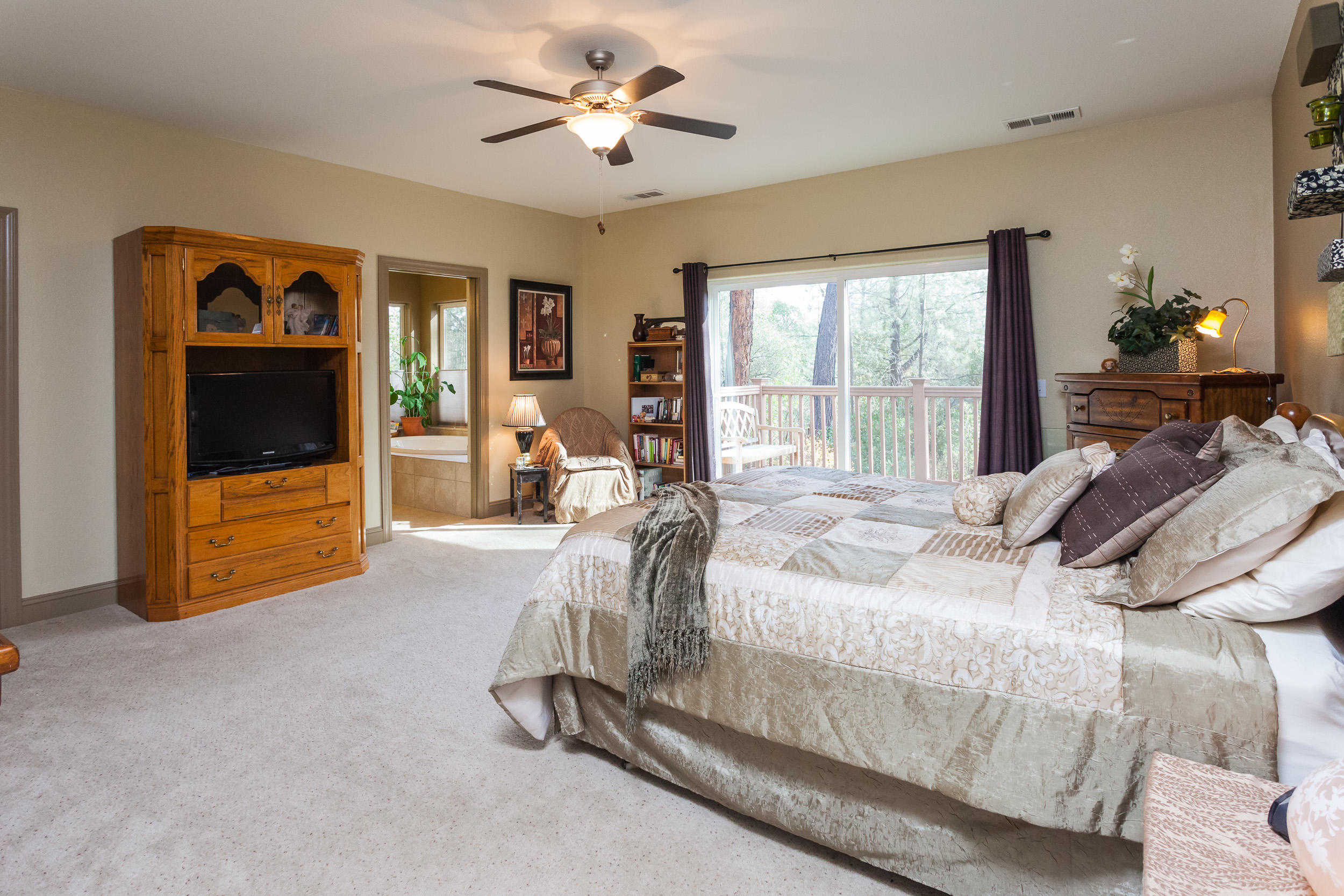 12199 Macs Road Redding, CA 96003 - Photo 27 of 36 a bed room with a bed and a television