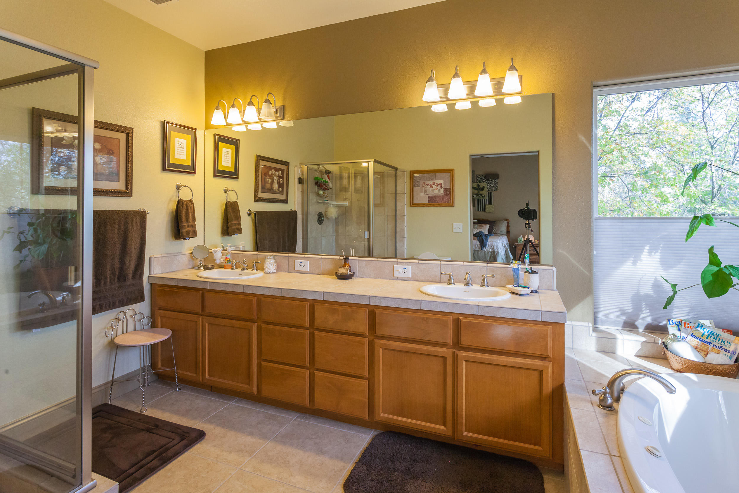 12199 Macs Road Redding, CA 96003 - Photo 29 of 36 a spacious bathroom with a double vanity sink a mirror and a shower
