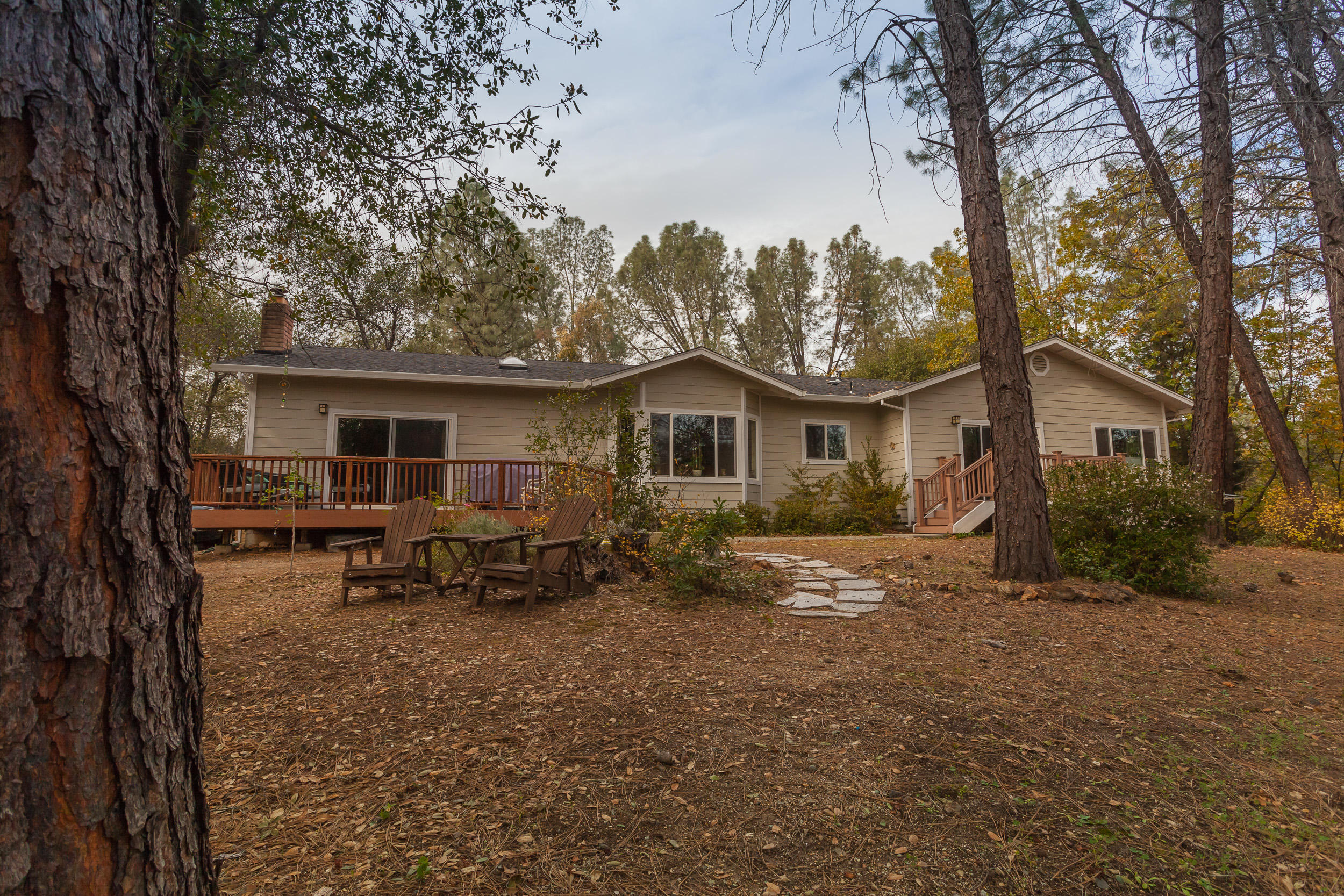 12199 Macs Road Redding, CA 96003 - Photo 34 of 36 a view of a house with a chairs in a patio