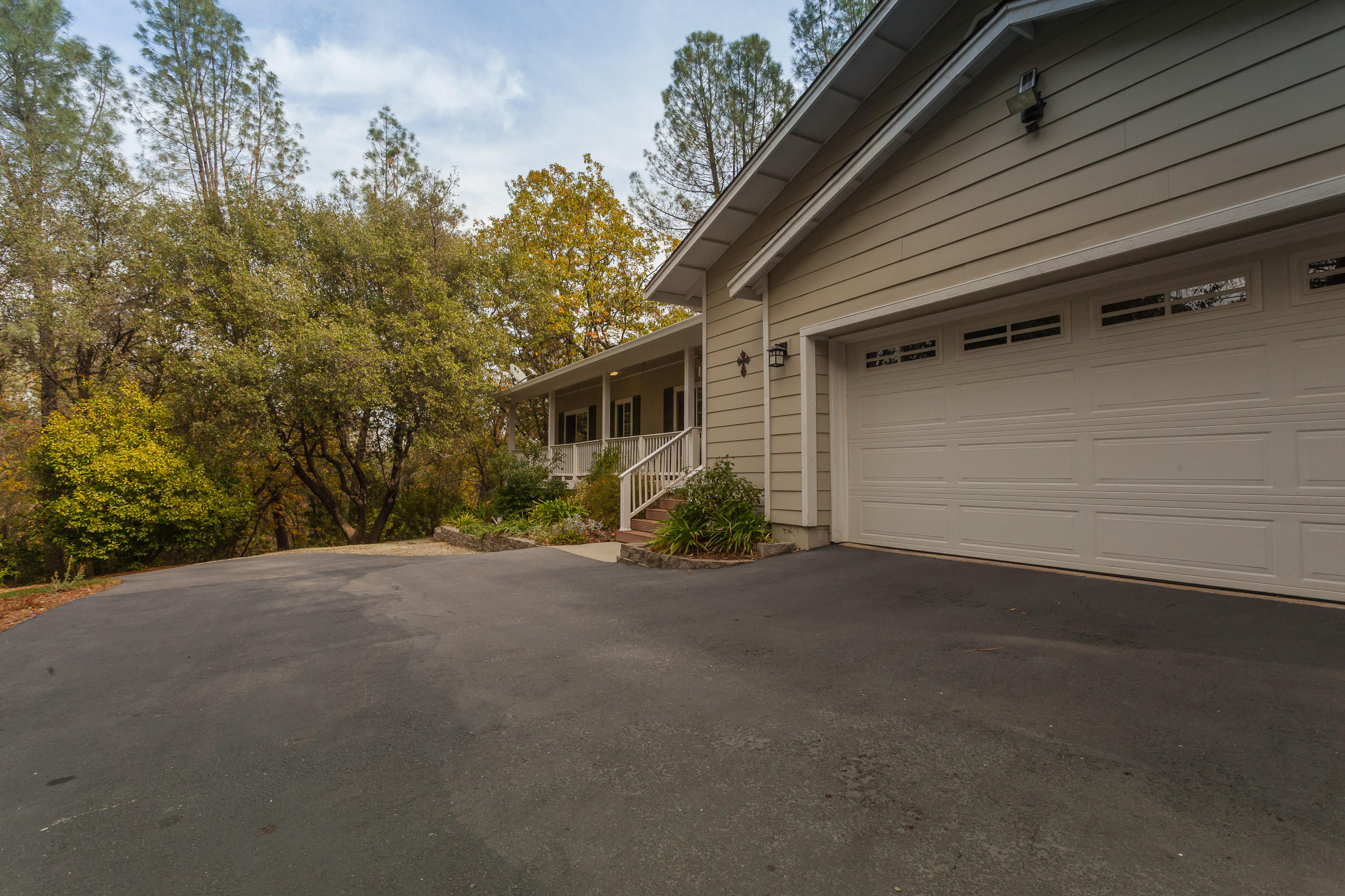 12199 Macs Road Redding, CA 96003 - Photo 5 of 36 a view of a house with a yard and garage