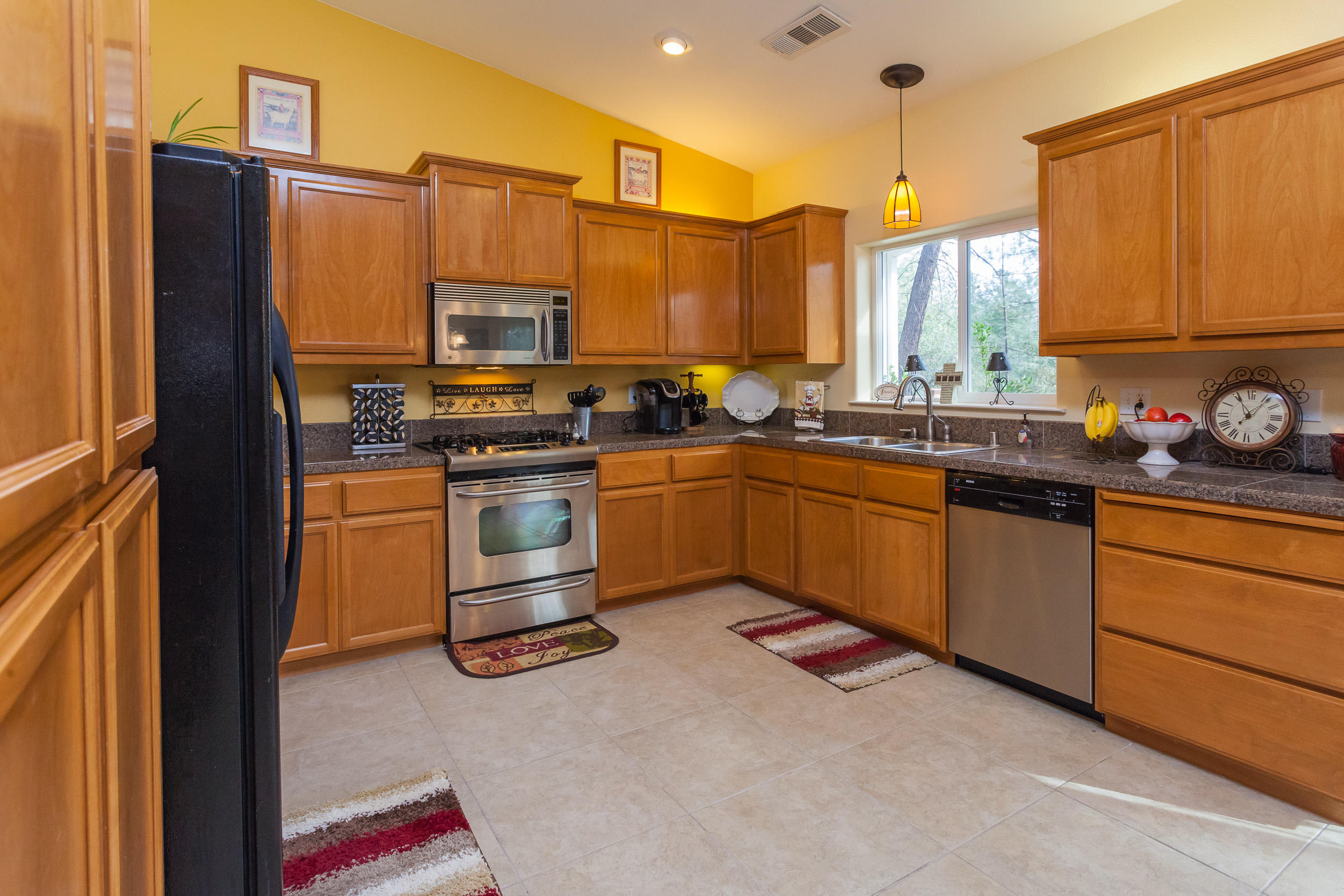 12199 Macs Road Redding, CA 96003 - Photo 10 of 36 a kitchen with stainless steel appliances a stove a sink and a refrigerator
