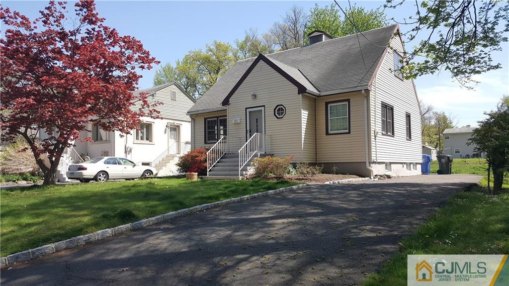 80 Jordan Road Colonia, NJ 07067 - Photo 1 of 21 a front view of a house with a garden and trees