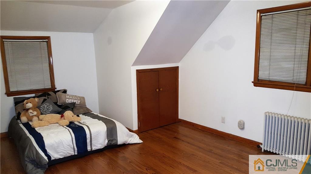 80 Jordan Road Colonia, NJ 07067 - Photo 19 of 21 a bedroom with a bed and wooden floor