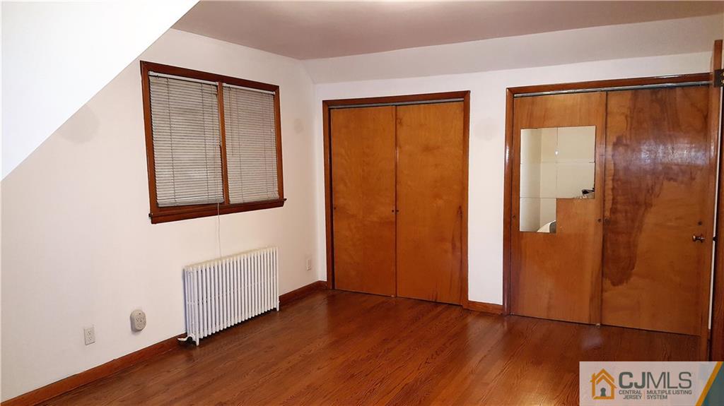 80 Jordan Road Colonia, NJ 07067 - Photo 20 of 21 an empty room with wooden floor and a window
