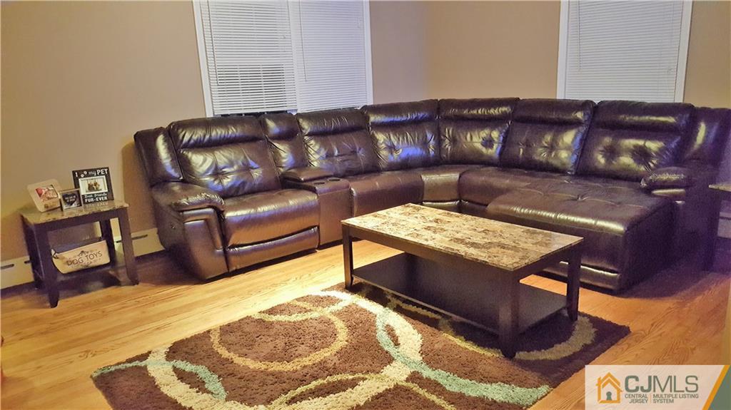 80 Jordan Road Colonia, NJ 07067 - Photo 3 of 21 a living room with a couch and a coffee table