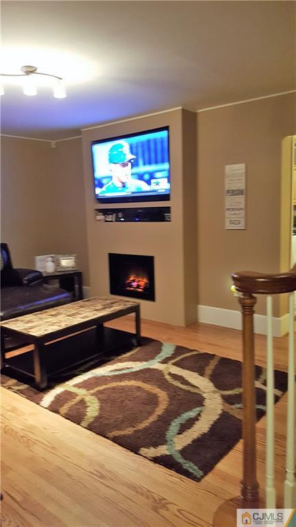80 Jordan Road Colonia, NJ 07067 - Photo 6 of 21 a living room with a flat screen tv and a fireplace