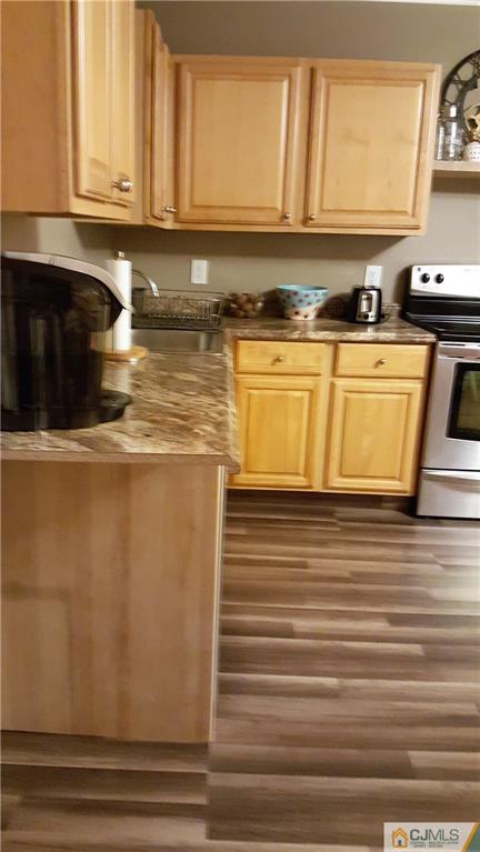 80 Jordan Road Colonia, NJ 07067 - Photo 7 of 21 a kitchen with stainless steel appliances granite countertop a sink a stove and a microwave