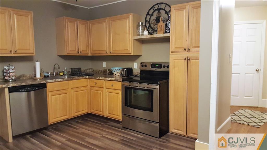 80 Jordan Road Colonia, NJ 07067 - Photo 8 of 21 a kitchen with stainless steel appliances granite countertop a stove a sink and white cabinets with wooden floor
