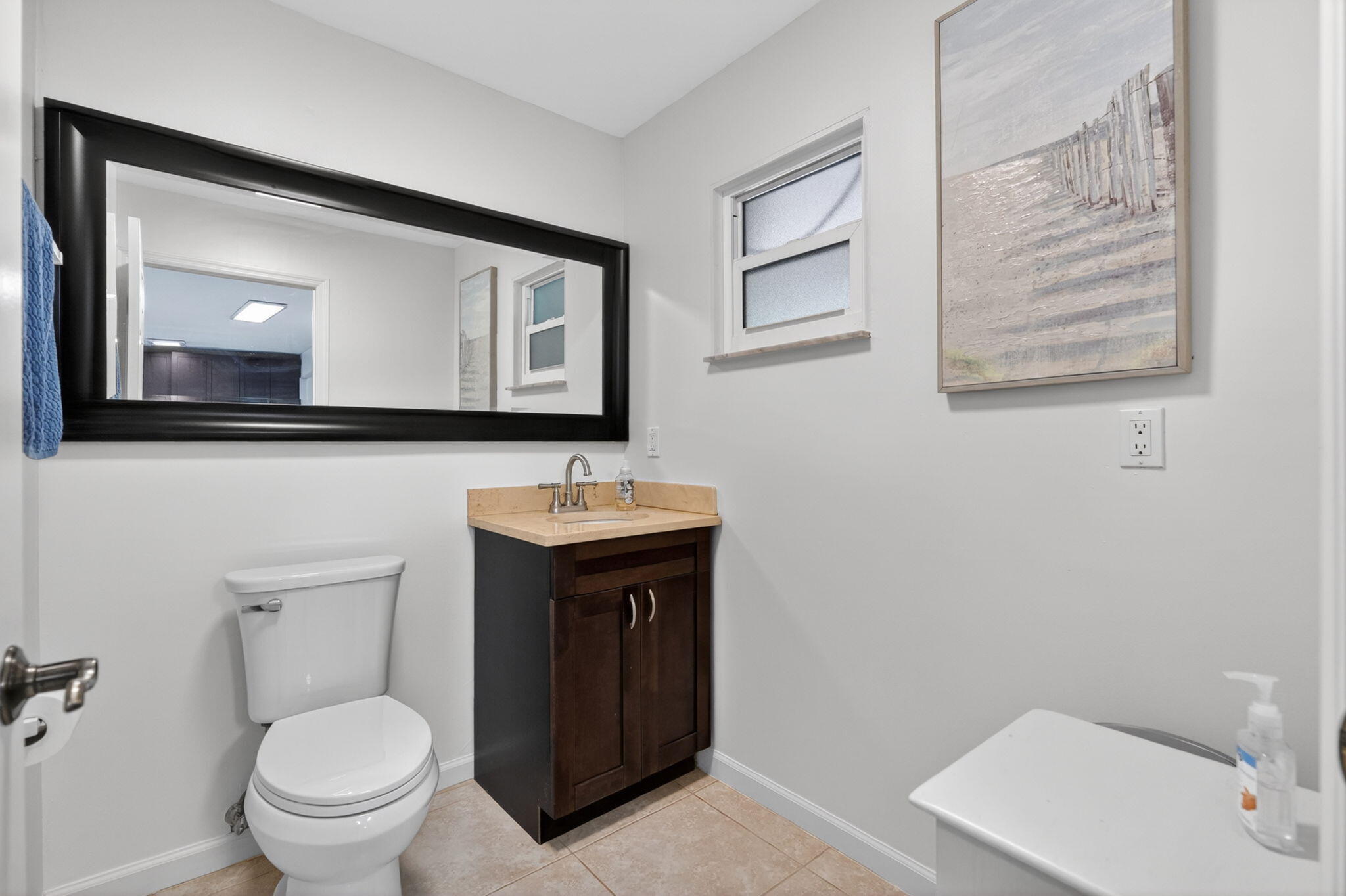 17391 Alexander Run Jupiter, FL 33478 - Photo 24 of 55 a bathroom with a toilet sink and mirror