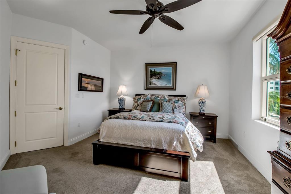 128 Golden Gate Point, Unit 301B Sarasota, FL 34236 - Photo 12 of 34 a spacious bedroom with a bed and a window