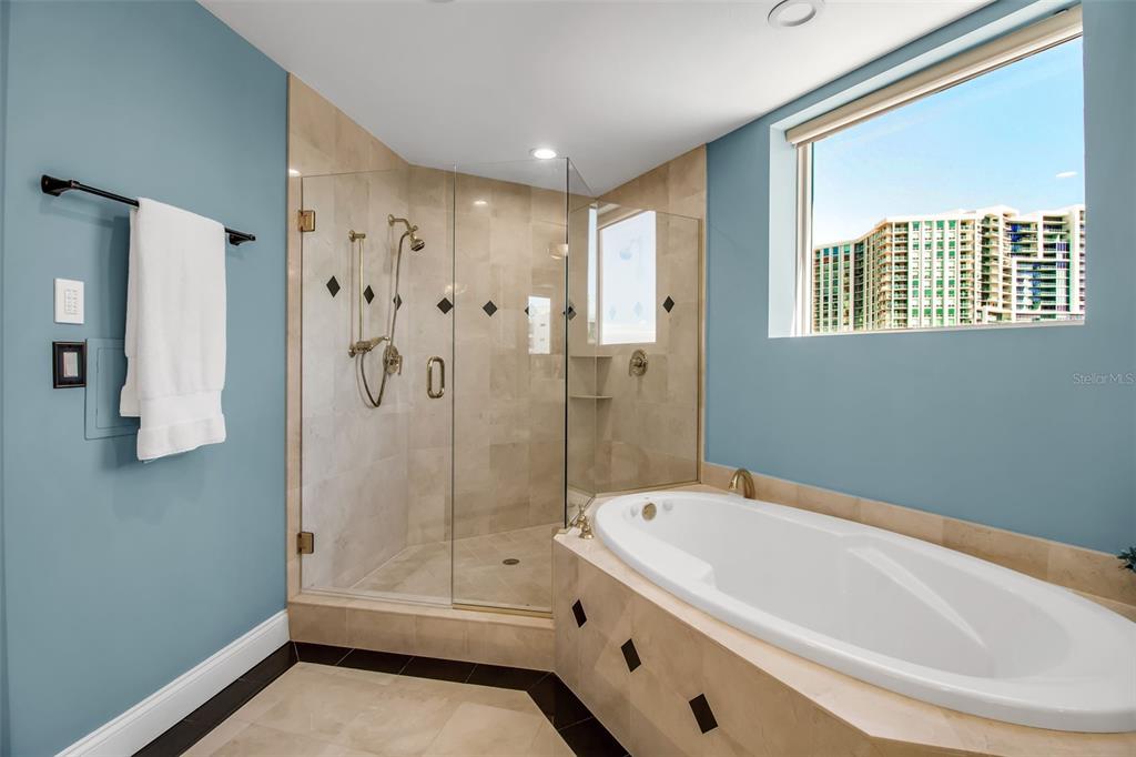 128 Golden Gate Point, Unit 301B Sarasota, FL 34236 - Photo 15 of 34 a bathroom with a tub and a shower