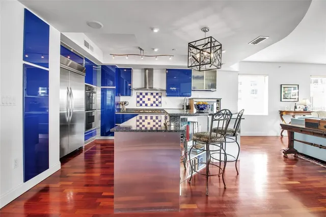 a view of a dining room with furniture wooden floor and chandelier