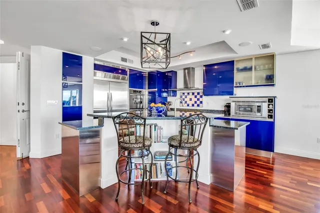 a view of a dining room with furniture wooden floor and chandelier