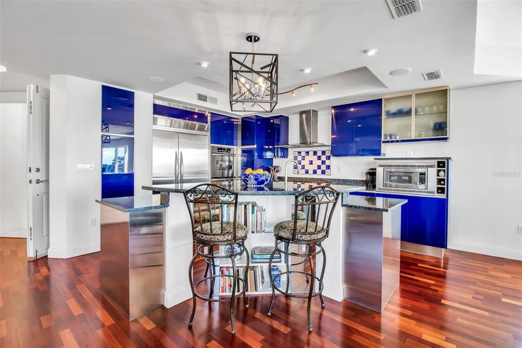 128 Golden Gate Point, Unit 301B Sarasota, FL 34236 - Photo 22 of 34 a view of a dining room with furniture wooden floor and chandelier