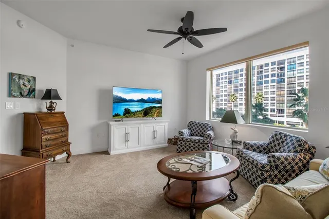 a living room with furniture a window and a flat screen tv