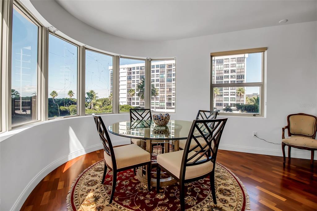 128 Golden Gate Point, Unit 301B Sarasota, FL 34236 - Photo 3 of 34 a view of a dining room with furniture window and wooden floor