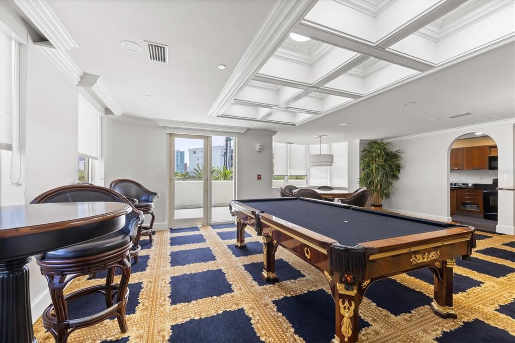 128 Golden Gate Point, Unit 301B Sarasota, FL 34236 - Photo 33 of 34 a room with gym equipment and a rug