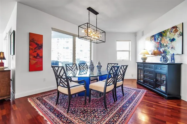 a dining room with furniture a rug and wooden floor
