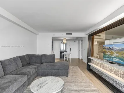 a living room with furniture and a large window