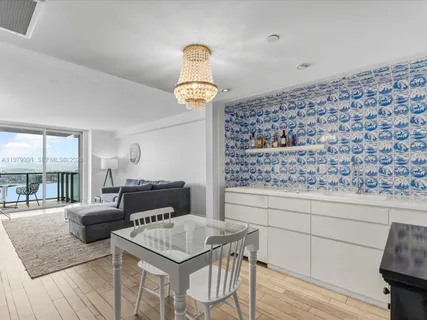 a kitchen with a table chairs and wooden floor