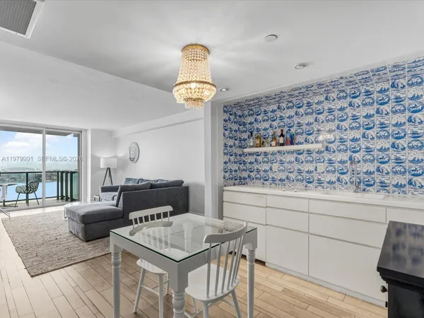 a kitchen with a table chairs and wooden floor