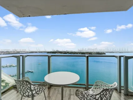 a view of a balcony with chair and chandelier