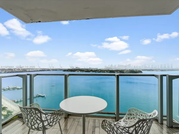 a view of a balcony with chair and chandelier