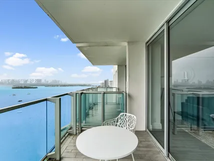 a view of a big yard with plants and large trees