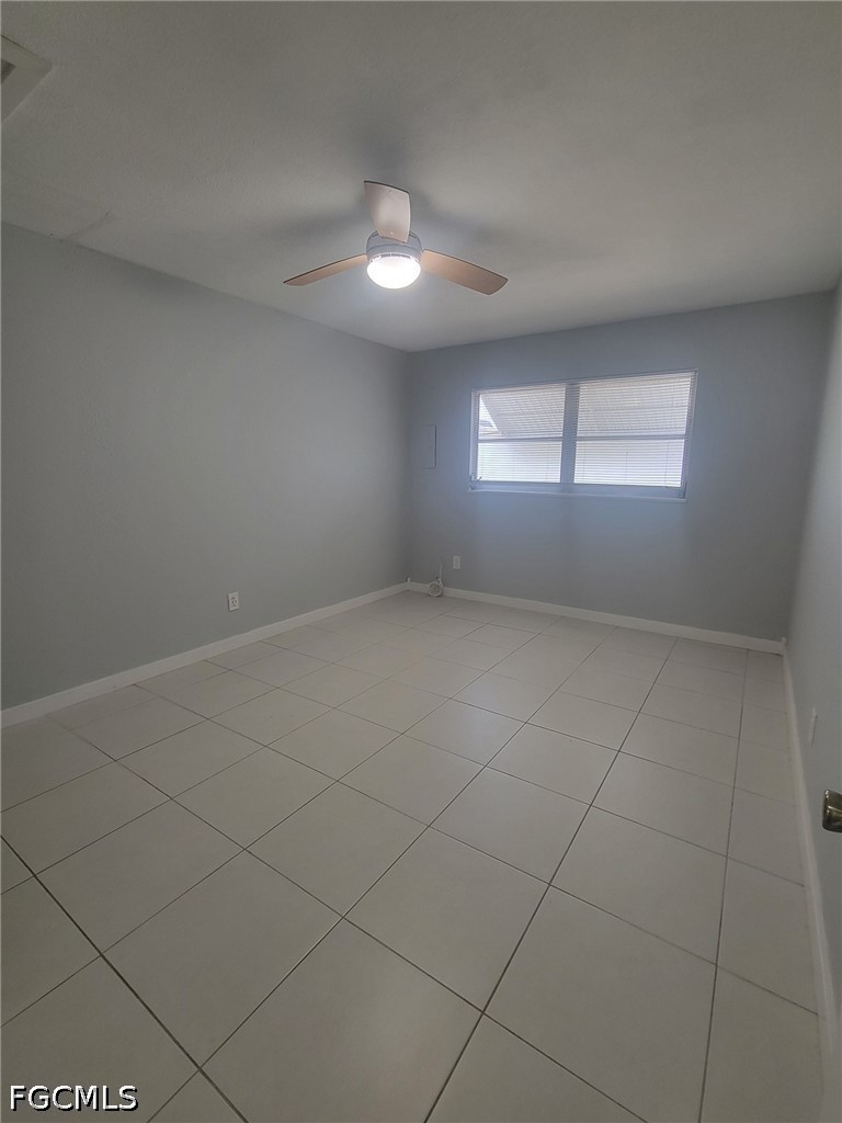 47 Tangelo Court Lehigh Acres, FL 33936 - Photo 12 of 18 an empty room with a empty space and windows
