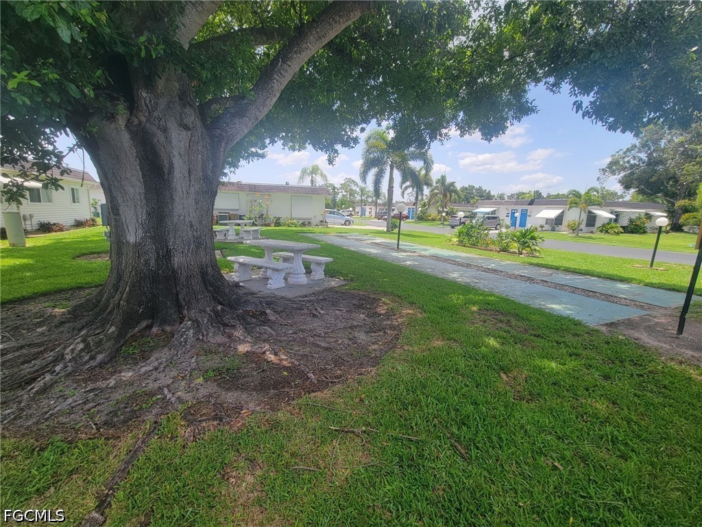 47 Tangelo Court Lehigh Acres, FL 33936 - Photo 18 of 18 a view of a yard with large trees