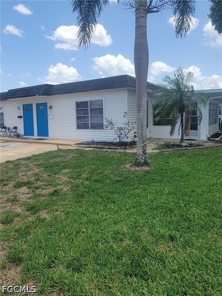 47 Tangelo Court Lehigh Acres, FL 33936 - Photo 2 of 18 a backyard of a house with table and chairs