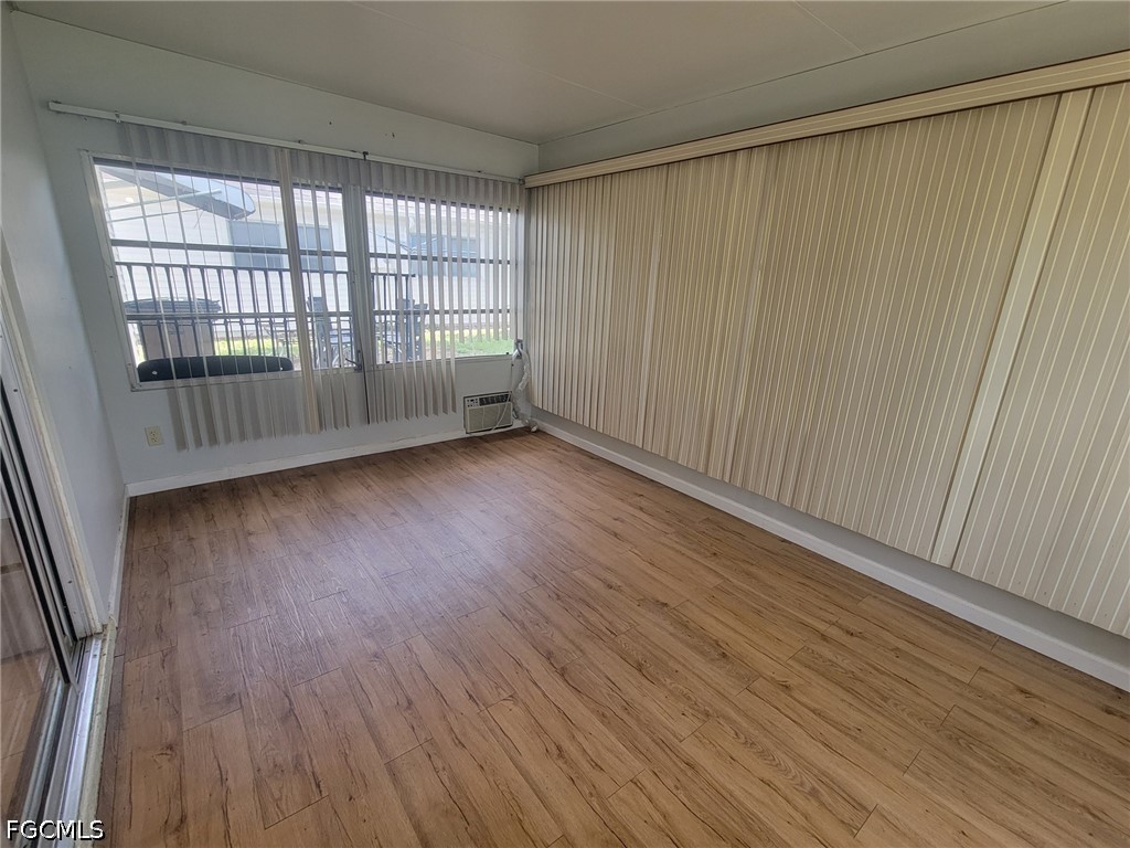 47 Tangelo Court Lehigh Acres, FL 33936 - Photo 8 of 18 an empty room with wooden floor and windows