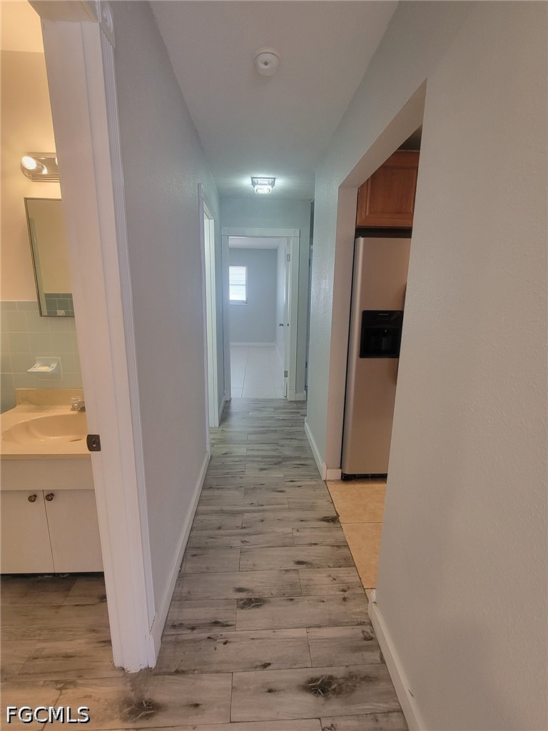 47 Tangelo Court Lehigh Acres, FL 33936 - Photo 10 of 18 a view of a hallway with wooden floor and staircase