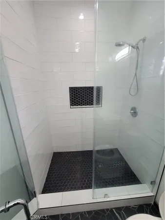 a bathroom with a toilet and a shower