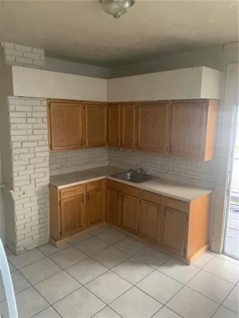 a kitchen with cabinets and white countertops