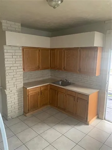 a kitchen with cabinets and white countertops