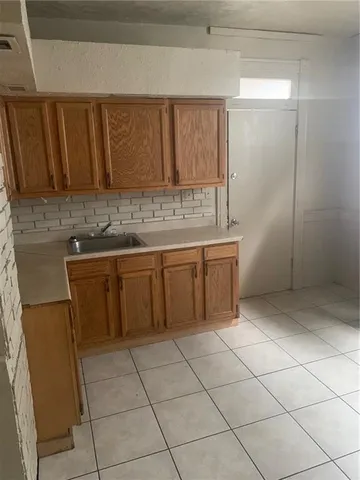 a kitchen with a sink and cabinets